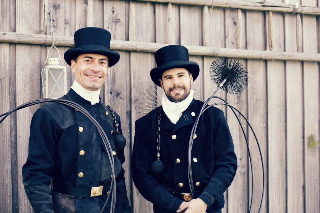 Portrait of two smiling chimney sweeps